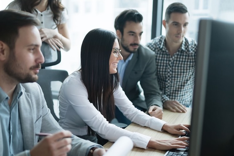 Advertisers with advertiser insurance working on a computer