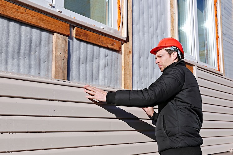 Man with cladding installer insurance installing cladding