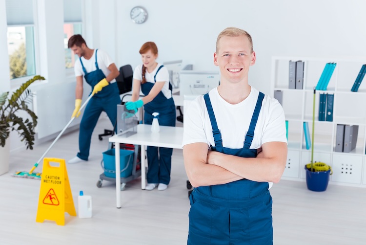 Man with cleaners insurance wearing overalls