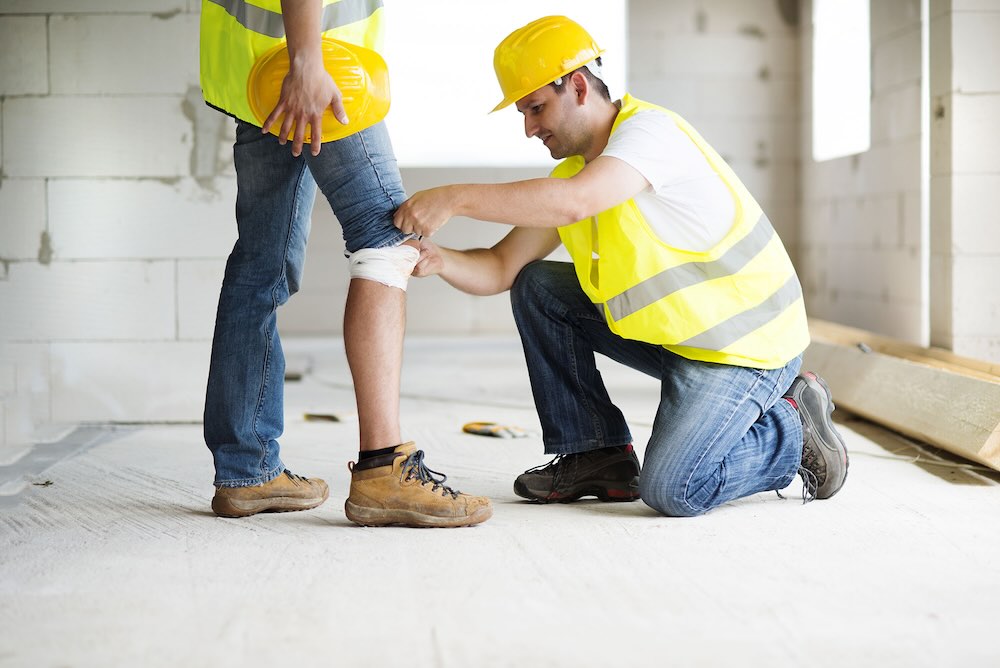 Man with personal accident and illness insurance getting his knee bandaged