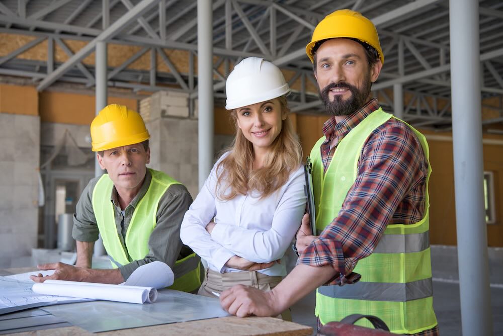 Contractors with professional indemnity insurance drawing building plans