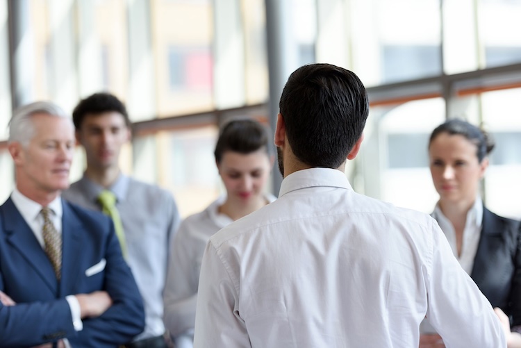 Man with event management insurance talking to a group