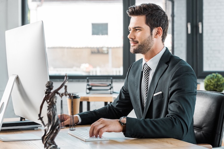 Man with lawyers insurance sitting at his desk