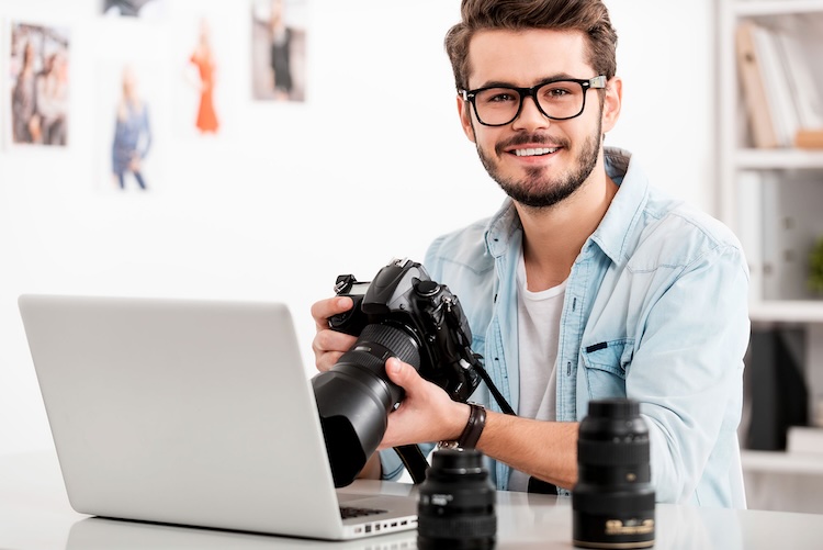 Man with photographer and videographer insurance holding a camera