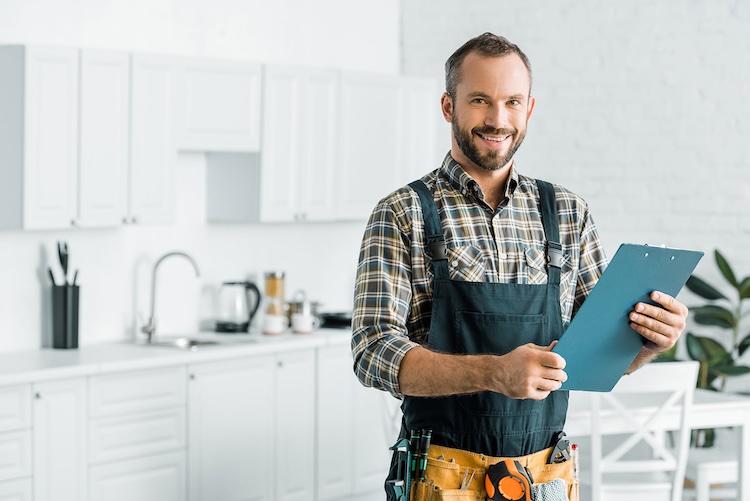 Man with plumbers insurance holding a clipboard