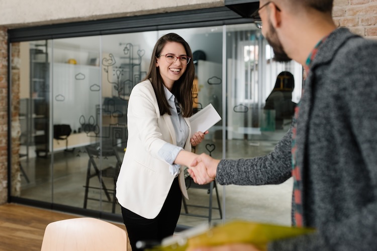 Woman with recruitment agent insurance shaking a man's hand