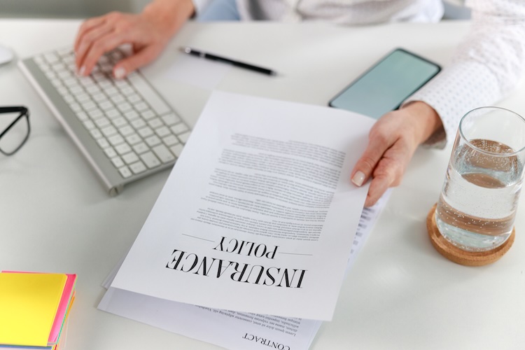Business woman examining a certificate of insurance