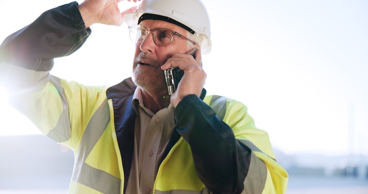 Man in hi vis calling about professional indemnity insurance