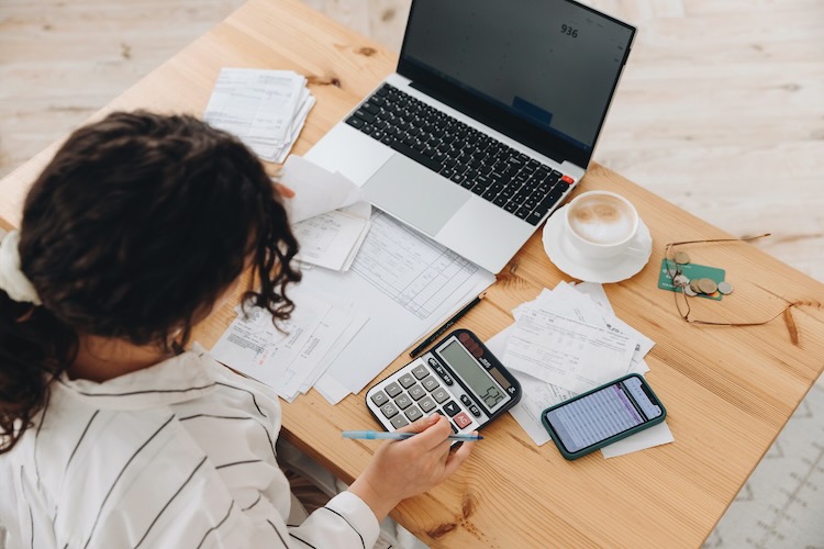 Woman stressed during a tax audit reviewing bank statements
