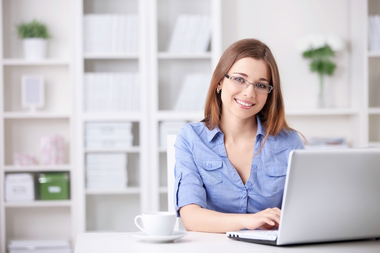 Woman with writers insurance writing on her laptop